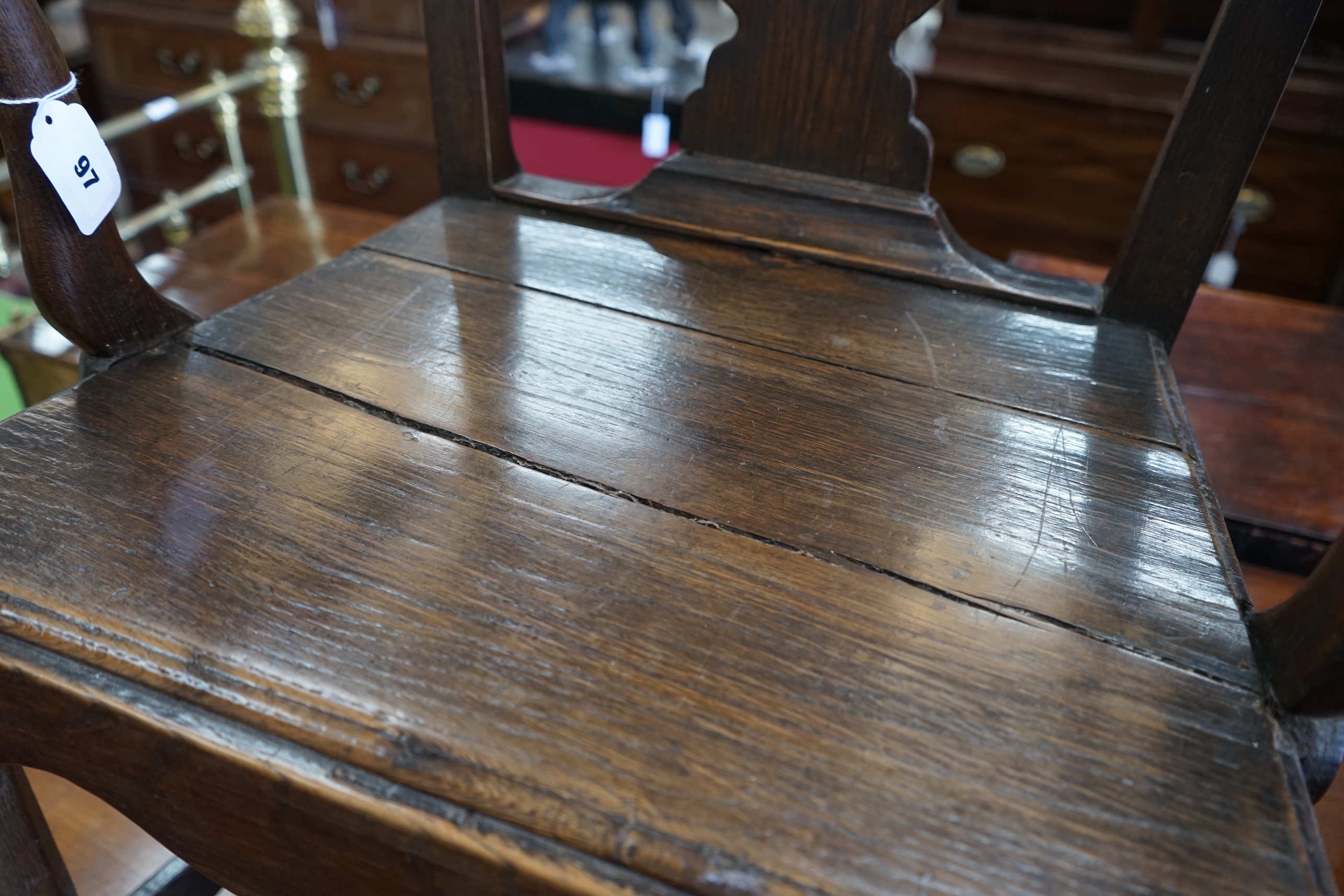 A George III oak open armchair and two similar side chairs